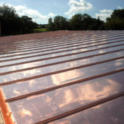 Vented cold copper roof with 150mm copper guttering and down pipes on new build in Wiveliscombe, Somerset © Mike White Ltd