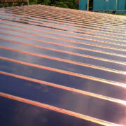 Vented cold copper roof with 150mm copper guttering and down pipes on new build in Wiveliscombe, Somerset © Mike White Ltd