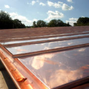Vented cold copper roof with 150mm copper guttering and down pipes on new build in Wiveliscombe, Somerset © Mike White Ltd