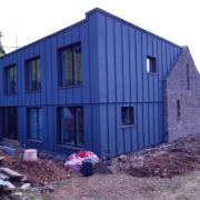 ZM Silesia pre-aged Zinc cladding with VM Zinc Pigmento Red window reveals in Crowcombe, Somerset