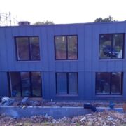 ZM Silesia pre-aged Zinc cladding with VM Zinc Pigmento Red window reveals in Crowcombe, Somerset