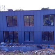 ZM Silesia pre-aged Zinc cladding with VM Zinc Pigmento Red window reveals in Crowcombe, Somerset
