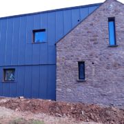 ZM Silesia pre-aged Zinc cladding with VM Zinc Pigmento Red window reveals in Crowcombe, Somerset